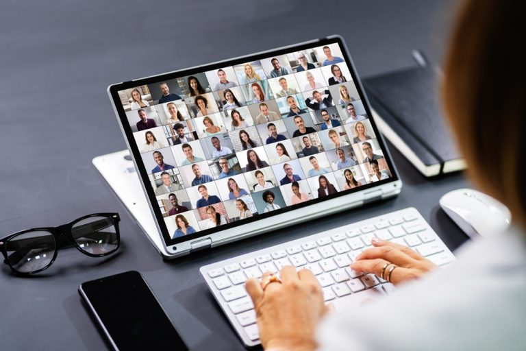 A specialist from Miller Tanner Associates plans a hybrid event for a company remotely on her laptop